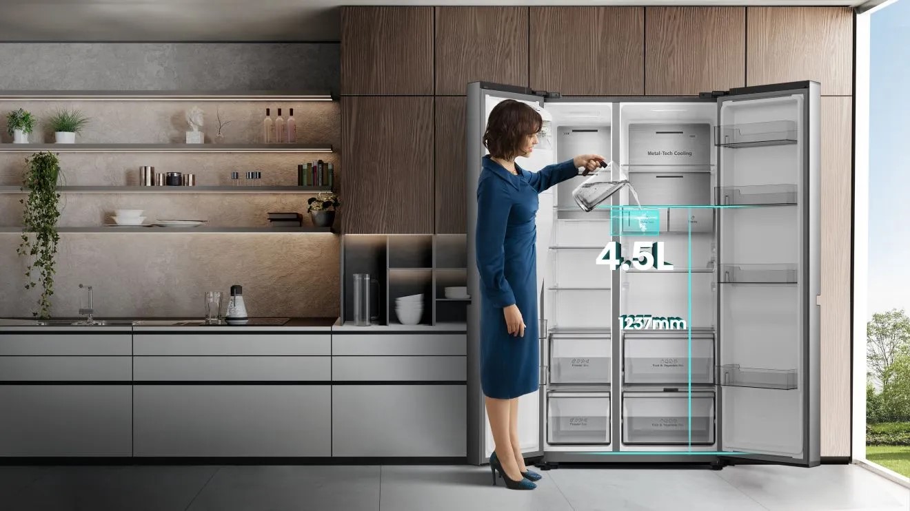 A person getting water from the dispenser in their fridge A person getting water from the dispenser in their fridge